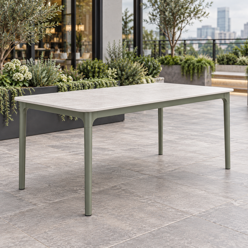 Illustrative AI concept, not manufacturer product photography. Generic weather-resistant outdoor dining table with pale top and sage aluminum frame.