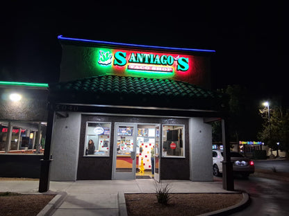 Illuminated restaurant storefront sign with dimensional letters at night.