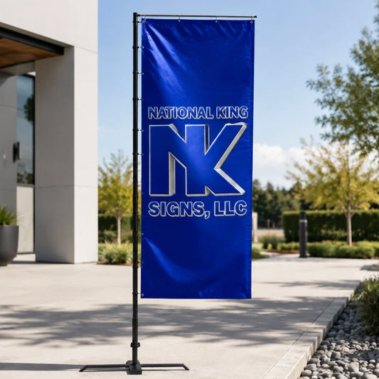 National King Signs branded blue rectangular promotional flag on a black pole with cross base outside a modern building.